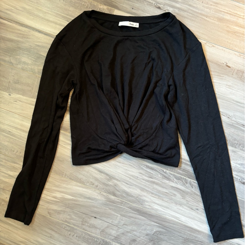 Black long sleeve front knit crop shirt, hits about the belly button.